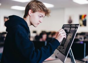 Gen Z student focusing on tech project with AI assistance.”